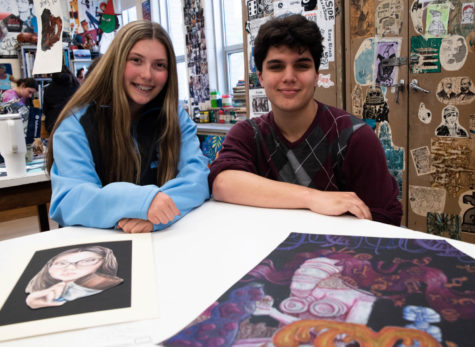 Anna McConnell and Tyson Seiben with their artwork.